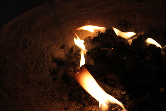 Oudh being lit with fire an incense